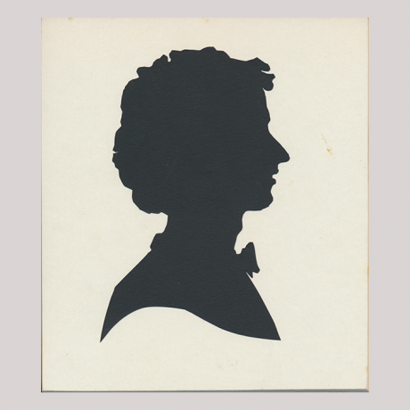 
        Front of silhouette, with man looking right, wearing a bow tie.